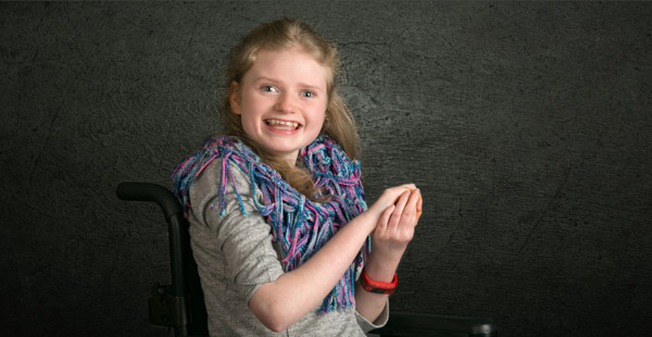 Photographing children. Girl in a wheelchair portrait